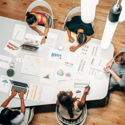 Diverse team collaborating on marketing strategy in a modern office setting.