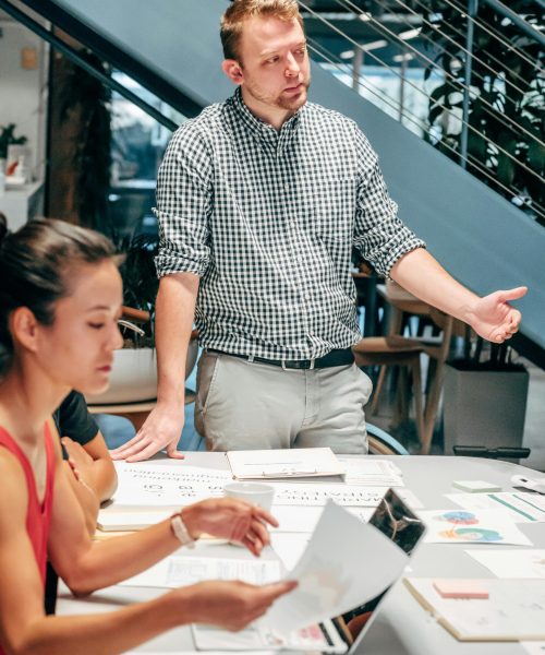Diverse team collaborating in a modern office setting, discussing project details.